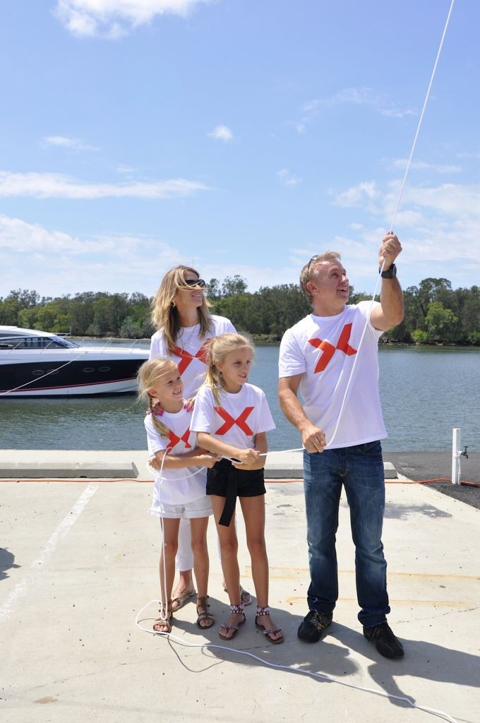 Russell Ingall and family hoist the giant X flag to mark the opening of the Gold Coast Marine Expo &copy; Stephen Milne